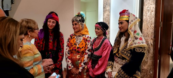 A group of women wearing colorful clothes

Description automatically generated