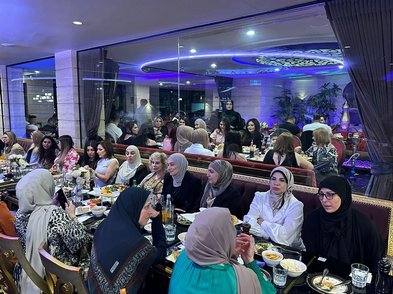 A group of women sitting at a table

Description automatically generated