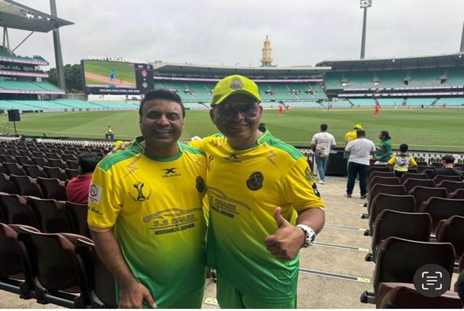 Two men in yellow and green uniforms standing in a stadium

Description automatically generated