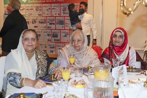 A group of women sitting at a table

Description automatically generated