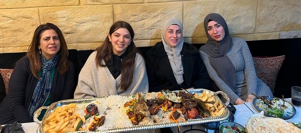 A group of women sitting at a table with food

Description automatically generated