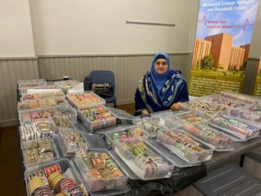 A person sitting at a table with plastic containers of food

Description automatically generated