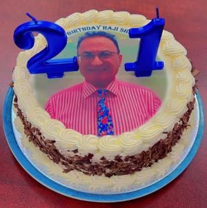 A cake with a picture of a person

Description automatically generated