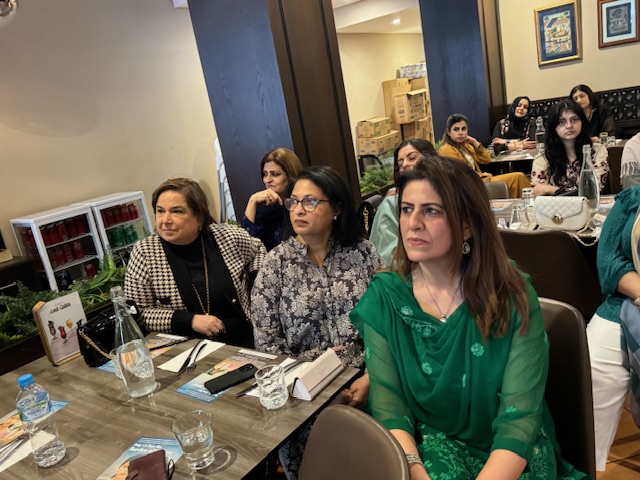 A group of women sitting at a table

Description automatically generated