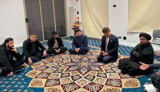 A group of men sitting on a rug

Description automatically generated