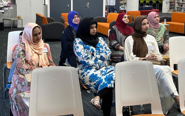 A group of women sitting in chairs

Description automatically generated