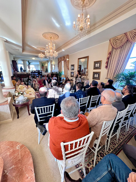 A group of people sitting in chairs in a room

Description automatically generated