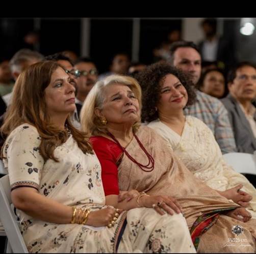 A group of women sitting in chairs

Description automatically generated