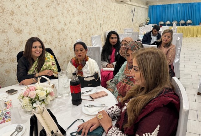 A group of women sitting at a table

Description automatically generated