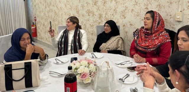 A group of women sitting at a table

Description automatically generated