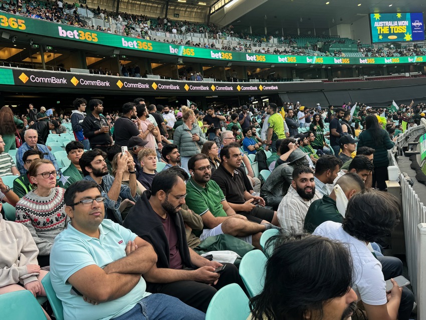 A crowd of people sitting in a stadium

Description automatically generated