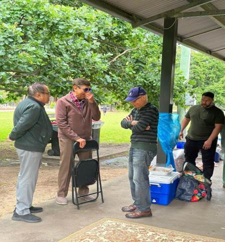 A group of men standing under a canopy

Description automatically generated