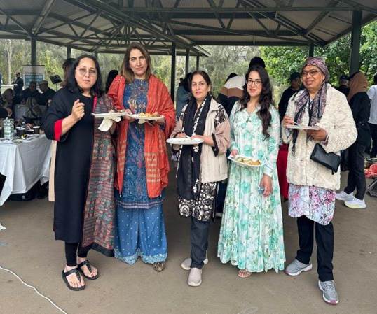 A group of women holding plates

Description automatically generated