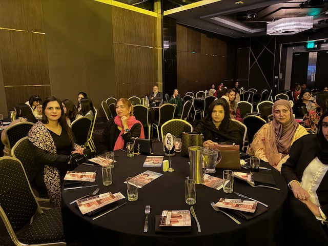 A group of women sitting at a round table

Description automatically generated