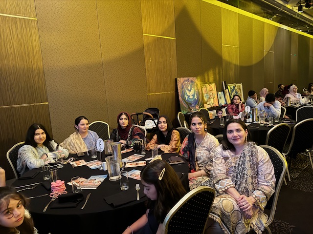 A group of women sitting at a table

Description automatically generated