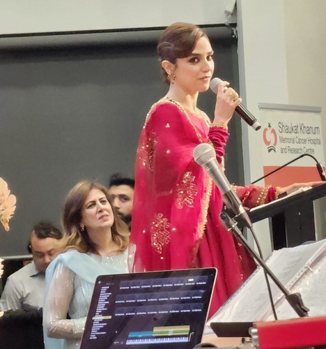 A person in a red dress holding a microphone

AI-generated content may be incorrect.