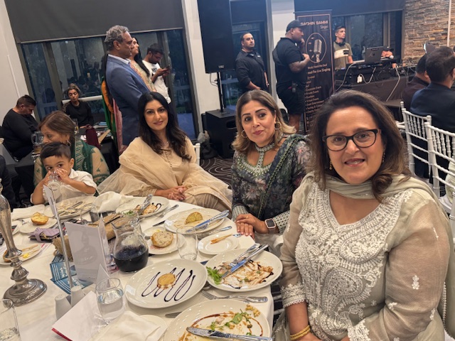 A group of women sitting at a table with plates of food

AI-generated content may be incorrect.